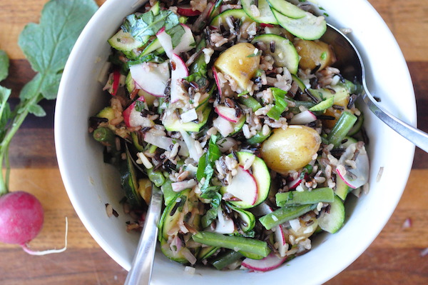 close up salad with raddish in background